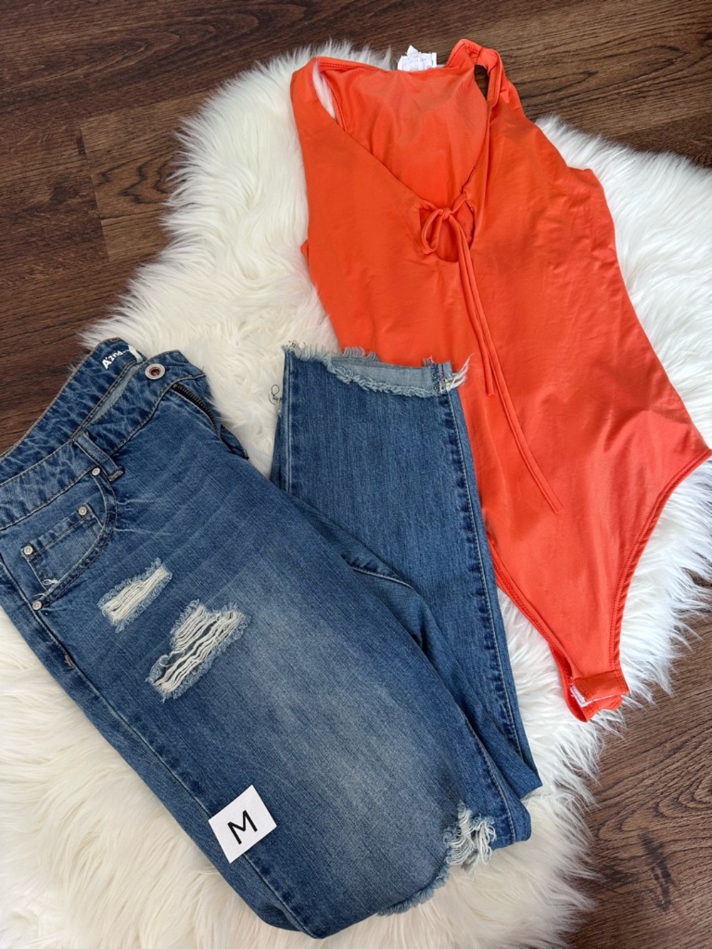 Bright Orange Sleeveless Bodysuit and jeans